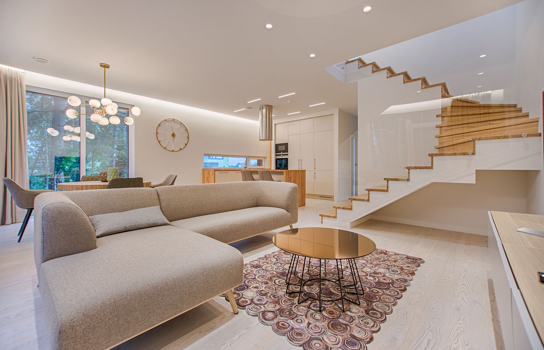 A bright, welcoming living room with comfortable seating and a garden view